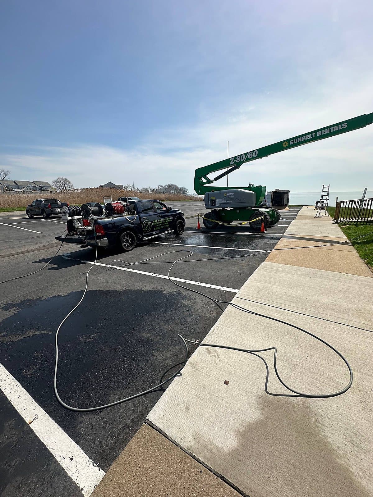 Boom lift staged for a commercial wash near the lake in Metro Detroit