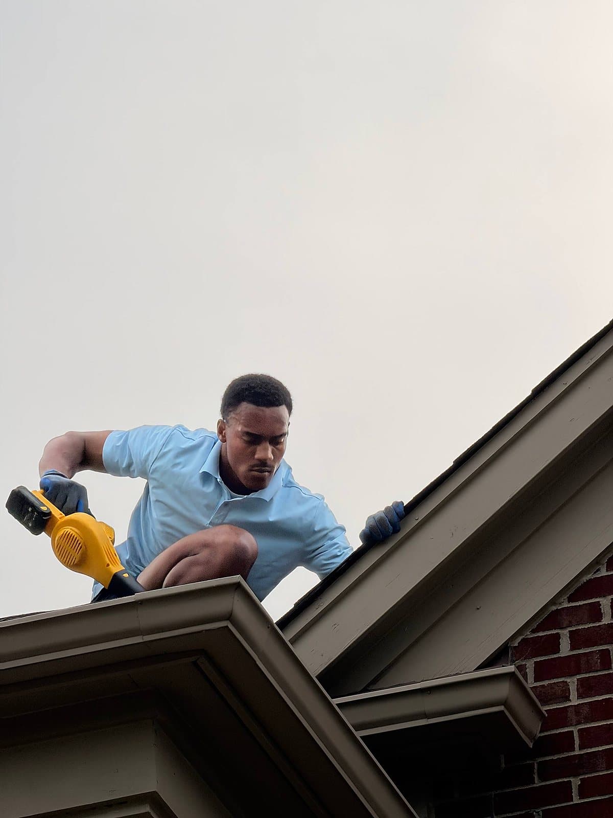 Crew finishing a gutter cleanout in Macomb County
