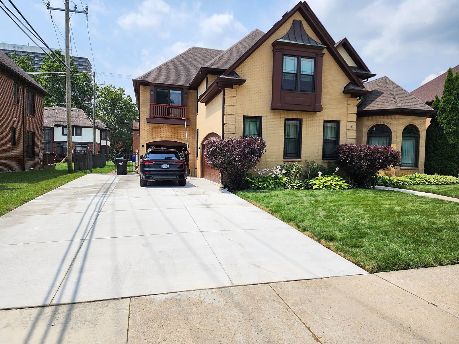 Reaching a second story window from the driveway with a pole in Metro Detroit