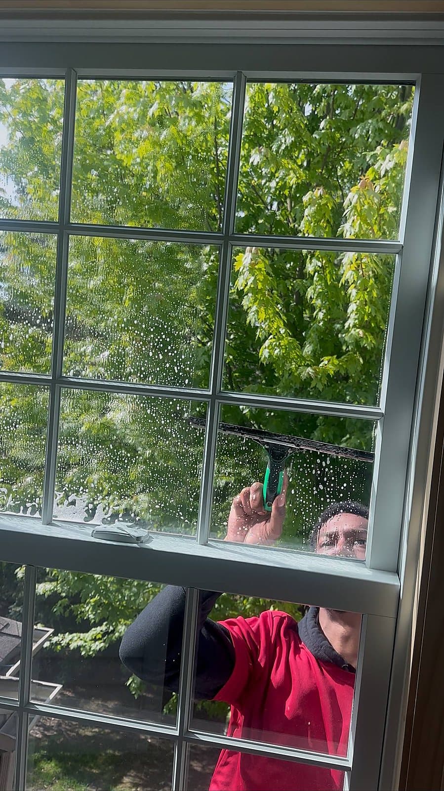 Squeegee pass on a window cleaning job in Macomb, MI