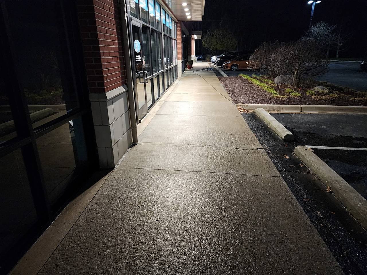 Commercial walkway concrete cleaned at night in Metro Detroit